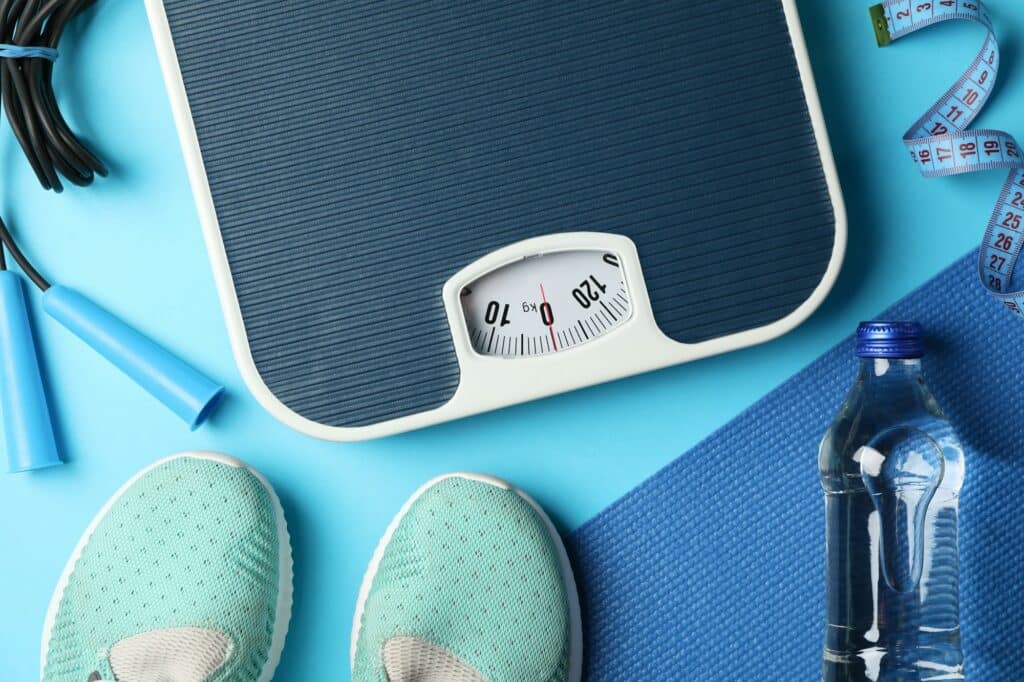 Weight loss or healthy lifestyle accessories on blue background